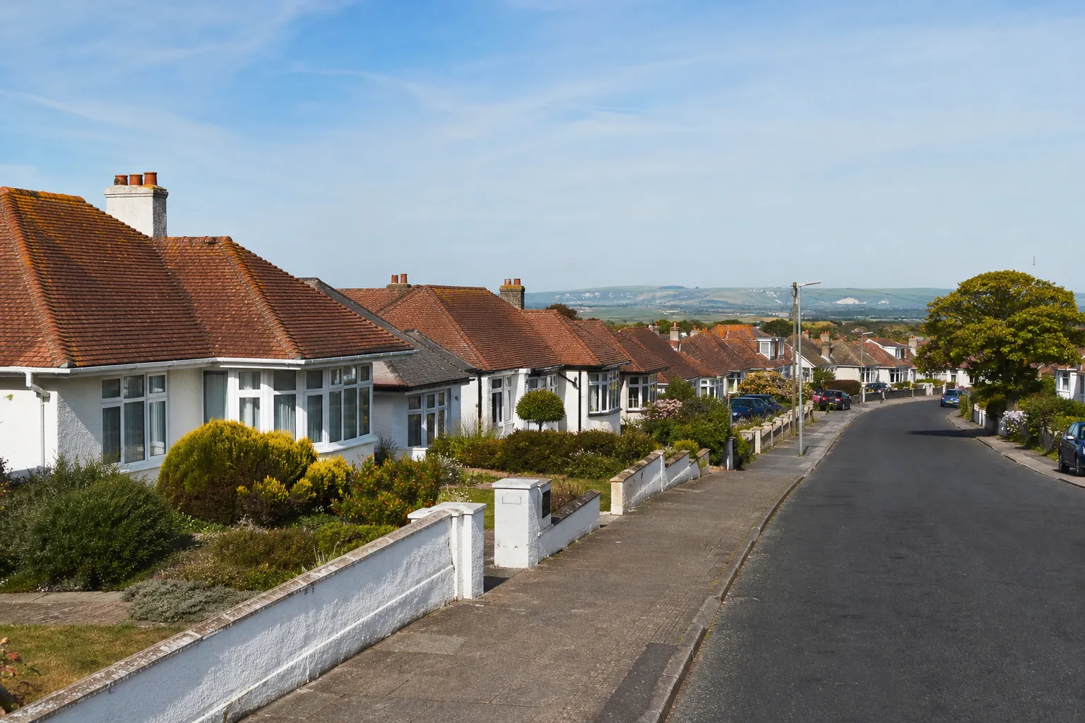 A street of 1930s hipped bungalows with clay tile roofs