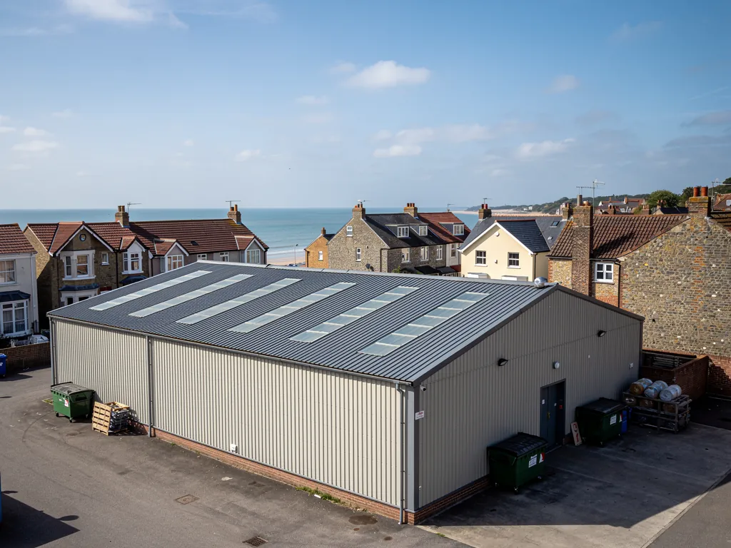 An industrial unit with a profiled metal roof and rooflights