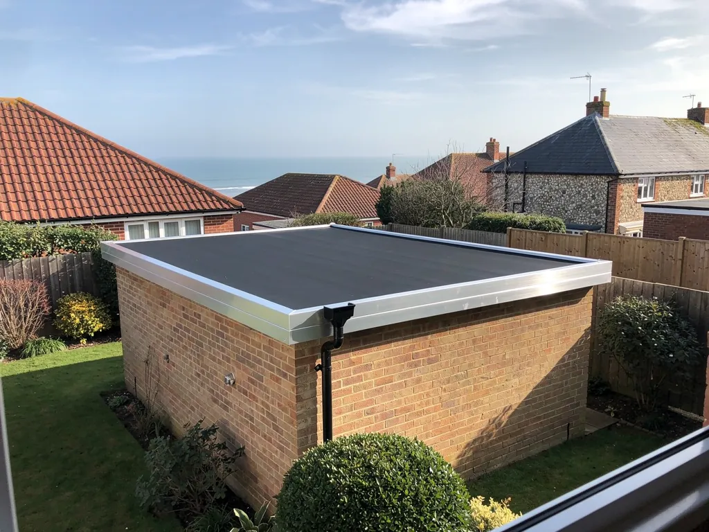 A brick garage with a new EPDM rubber roof and aluminium trims